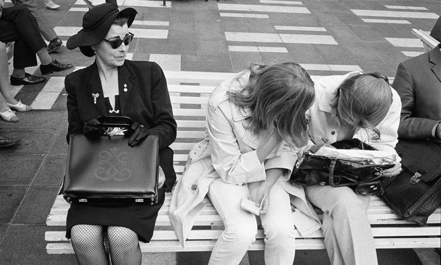 FOTOGRAFI Sergelgatan vid Sergelstorg. En kvinna och två ungdomar sitter på en bänk. 1965-1965 FOTOGRAF: Fredriksson, Göran H. BILDNUMMER: SSMFA002286 Stadsmuseet i Stockholm
